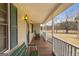 Charming covered porch with rocking chairs and a bench, offering a relaxing space with views of the expansive yard at 62 Honey Ln, Mcdonough, GA 30252