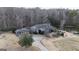 Home surrounded by a wooded area with a circular driveway and pond at 1187 Attaway Road, Roopville, GA 30170