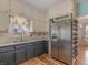 Kitchen featuring a stainless steel fridge, window view, and adjacent dining area at 135 Oakpark Ter, Mcdonough, GA 30253