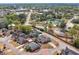 Aerial view of a neighborhood featuring a charming home, a pond, and nearby community buildings at 135 Oakpark Ter, Mcdonough, GA 30253