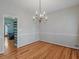 Dining room featuring a chandelier and hardwood floors next to a bar area at 135 Oakpark Ter, Mcdonough, GA 30253