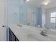 Bathroom featuring a double vanity, framed mirror, blue walls and shower/tub combo at 135 Oakpark Ter, Mcdonough, GA 30253