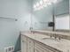 Bright bathroom with double sinks, granite counters, and a large mirror at 135 Oakpark Ter, Mcdonough, GA 30253