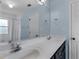 Bathroom featuring a double vanity, framed mirror, blue walls and shower/tub combo at 135 Oakpark Ter, Mcdonough, GA 30253