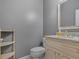 Powder room features a granite vanity and decorative mirror at 135 Oakpark Ter, Mcdonough, GA 30253
