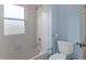 Bathroom featuring a white tiled shower-tub combo and blue walls at 135 Oakpark Ter, Mcdonough, GA 30253