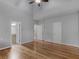 Bright bedroom features hardwood floors, ceiling fan, vaulted ceiling, and ensuite bathroom access at 135 Oakpark Ter, Mcdonough, GA 30253