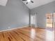 Bedroom featuring hardwood flooring, neutral paint, and a door to the backyard at 135 Oakpark Ter, Mcdonough, GA 30253