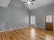 Bedroom featuring hardwood flooring, neutral paint, and a door to the exterior at 135 Oakpark Ter, Mcdonough, GA 30253