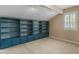 Bonus room offers built in shelving, window and neutral carpet at 135 Oakpark Ter, Mcdonough, GA 30253