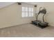 Carpeted exercise area with treadmill and natural light from the window at 135 Oakpark Ter, Mcdonough, GA 30253