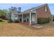 Charming home exterior featuring a welcoming covered porch and landscaped yard at 135 Oakpark Ter, Mcdonough, GA 30253
