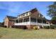 Exterior view of the home showing the large porch and well-maintained lawn at 135 Oakpark Ter, Mcdonough, GA 30253