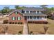 Two-story brick home with a large, welcoming front porch and well-maintained landscaping at 135 Oakpark Ter, Mcdonough, GA 30253