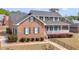 Attractive brick home with a large front porch and green shutters at 135 Oakpark Ter, Mcdonough, GA 30253