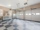 Spacious garage featuring checkerboard flooring, ample storage, and two garage door entries at 135 Oakpark Ter, Mcdonough, GA 30253