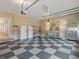 Organized garage with checkerboard floors, storage units, and ample workspace at 135 Oakpark Ter, Mcdonough, GA 30253