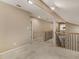 Open carpeted hallway with decorative railing and access to multiple rooms at 135 Oakpark Ter, Mcdonough, GA 30253
