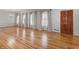Spacious living room with hardwood floors, lots of natural light, fresh paint, and a chandelier at 135 Oakpark Ter, Mcdonough, GA 30253