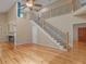 Open concept living room featuring a staircase, hardwood floors, and lots of natural light at 135 Oakpark Ter, Mcdonough, GA 30253