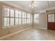 Bright sunroom with tile floor, plantation shutters, and lots of natural light at 135 Oakpark Ter, Mcdonough, GA 30253