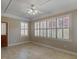 Light-filled sunroom with tile floor and plantation shutters on the windows at 135 Oakpark Ter, Mcdonough, GA 30253