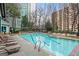 Relaxing community swimming pool surrounded by comfortable lounge chairs and manicured landscaping at 2870 Pharr Nw Ct # 2008, Atlanta, GA 30305