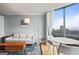 This condo has a cozy living room with bright sunlight, comfortable seating, and amazing views of the city at 2870 Pharr Nw Ct # 2008, Atlanta, GA 30305