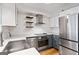 A bright kitchen features stainless steel appliances, white subway tile backsplash, light countertops, and modern lighting at 2870 Pharr Nw Ct # 2008, Atlanta, GA 30305