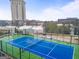 Top-down view of a community tennis court with a car park in the background at 2870 Pharr Nw Ct # 2008, Atlanta, GA 30305