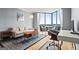Relax in the living room with floor-to-ceiling windows offering views, wood floors, and comfortable seating at 2870 Pharr Nw Ct # 2008, Atlanta, GA 30305