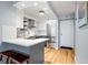 Galley-style kitchen with a stainless refrigerator, white cabinets, blue-gray cabinets, and stainless appliances at 2870 Pharr Nw Ct # 2008, Atlanta, GA 30305