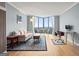 The living room features hardwood floors, a seating area, a work area, and large windows showcasing the amazing views at 2870 Pharr Nw Ct # 2008, Atlanta, GA 30305