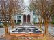 Impressive building entrance with a beautiful fountain, mature trees, and detailed architectural design at 2870 Pharr Nw Ct # 2008, Atlanta, GA 30305