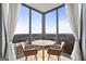 Bright dining area features floor-to-ceiling windows with city views and modern furnishings at 2870 Pharr Nw Ct # 2008, Atlanta, GA 30305