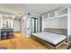 Well-lit living space with hardwood floors, stainless appliances, and a converted Murphy bed at 2870 Pharr Nw Ct # 2008, Atlanta, GA 30305