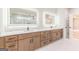 Bathroom with double vanity, framed mirrors, and tile flooring at 2015 Fontainbleau Dr, Conyers, GA 30094