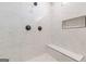 Bright and modern shower features marble tile, built-in niche, and a comfortable bench seat at 2015 Fontainbleau Dr, Conyers, GA 30094