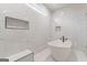 Bathroom boasts soaking tub, marble tile details, and built-in shower niche at 2015 Fontainbleau Dr, Conyers, GA 30094
