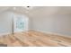 Bedroom with hardwood floors, leading to a modern, bright bathroom through double doors at 2015 Fontainbleau Dr, Conyers, GA 30094