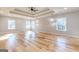 Large bedroom with tray ceilings, recessed lights, ceiling fan, and hardwood floors at 2015 Fontainbleau Dr, Conyers, GA 30094