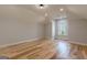 Well-lit bedroom with light hardwood flooring, neutral walls, and a view from the window at 2015 Fontainbleau Dr, Conyers, GA 30094