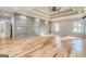 Spacious bedroom with decorative wall trim, tray ceilings, and hardwood floors at 2015 Fontainbleau Dr, Conyers, GA 30094