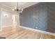 Elegant dining room with hardwood floors, stylish accent wall, and a modern chandelier at 2015 Fontainbleau Dr, Conyers, GA 30094