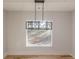 Bright dining room featuring a modern light fixture, wainscoting detail, and hardwood floors at 2015 Fontainbleau Dr, Conyers, GA 30094
