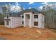 New construction home showing weather protection, black windows, and dark roof at 2015 Fontainbleau Dr, Conyers, GA 30094