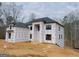 New construction home showing weather protection, black windows, and dark roof at 2015 Fontainbleau Dr, Conyers, GA 30094