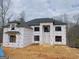 New construction home showing weather protection, black windows, and dark roof at 2015 Fontainbleau Dr, Conyers, GA 30094