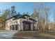 Elegant home featuring a three-car garage, stone accents, light brick and a manicured front yard at 2015 Fontainbleau Dr, Conyers, GA 30094