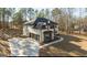Striking exterior showcasing a three-car garage, light brick, professional landscaping and a pristine driveway at 2015 Fontainbleau Dr, Conyers, GA 30094